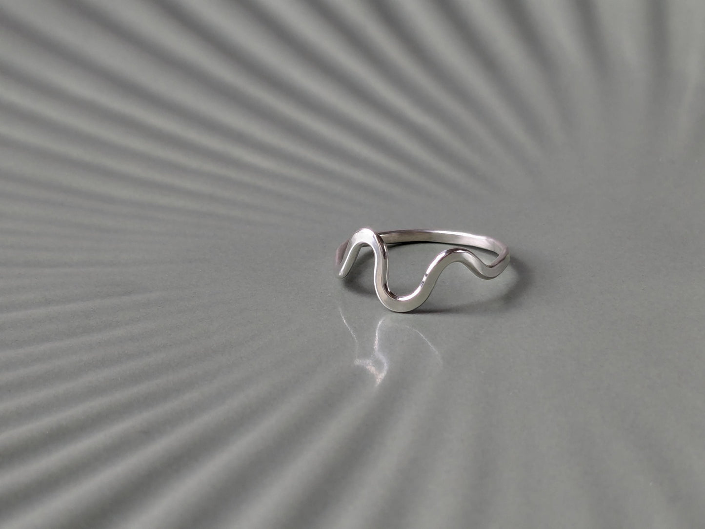 A wave-shaped sterling silver ring